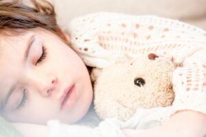 sleep dependency, teddy bear, stuffed animal. Girl sleeping with a teddy bear